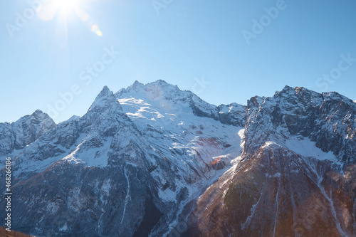 Dombay, alps, snow-covered slopes, the first snow in the mountains, sun and good weather, winter ski season photo