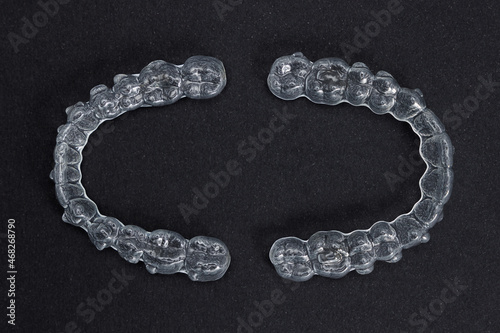 Two transparent retainers on black background. Invisalign orthodontics concept