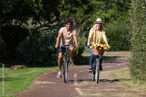 young couple is cycling in the forest