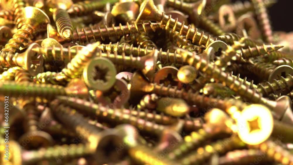 Golden screws or cross head screws rotate like background, construction supplies self-tapping screws or bolts Golden screws or cross head screws rotate like background, construction supplies self-tapping screws or bolts