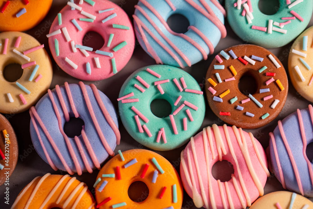 Donats from sugar paste. Multi-colored sugar art cakes. Different types of colorful Donats decorated sprinkles and icing. Cake art concept image Donats from sugar paste. Multi-colored sugar art cakes. Different types of colorful Donats decorated sprinkles and icing. Cake art concept image