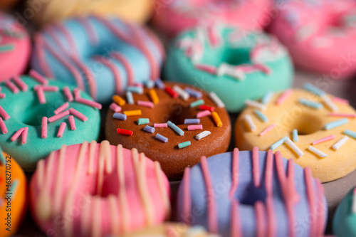 Donats from sugar paste. Multi-colored sugar art cakes. Different types of colorful Donats decorated sprinkles and icing. Cake art concept image photo