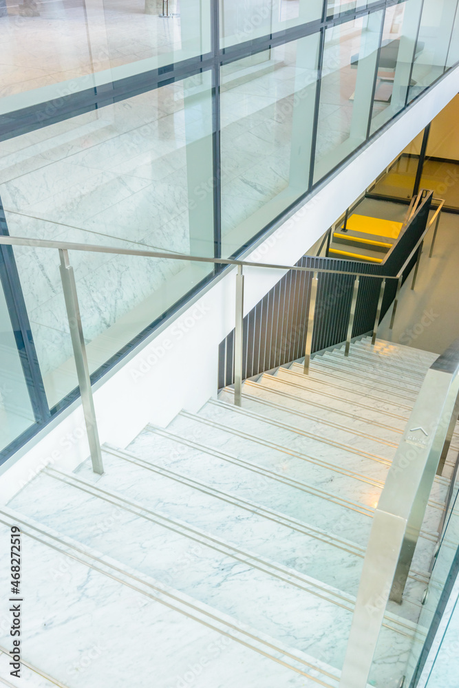Obraz premium White staircase. Abstract fragment of the architecture of modern lobby, hallway of the luxury hotel, shopping mall, business center in Vancouver, Canada. Interior design.