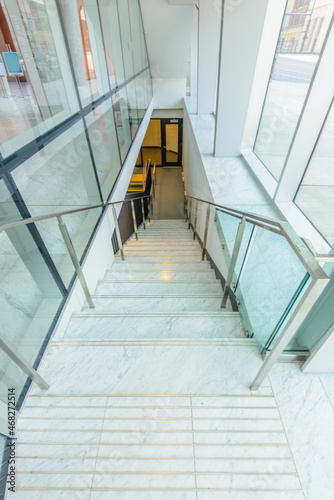 White staircase. Abstract fragment of the architecture of modern lobby, hallway of the luxury hotel, shopping mall, business center in Vancouver, Canada. Interior design. © karamysh