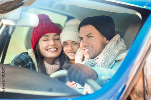 Happy family sitting in car...