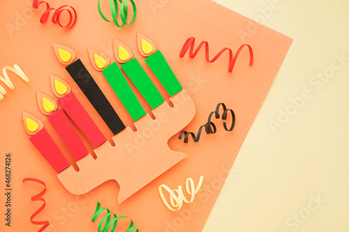 Happy Kwanzaa Greeting Card Background. Candleholder made from paper leaves. Paper art concept photo