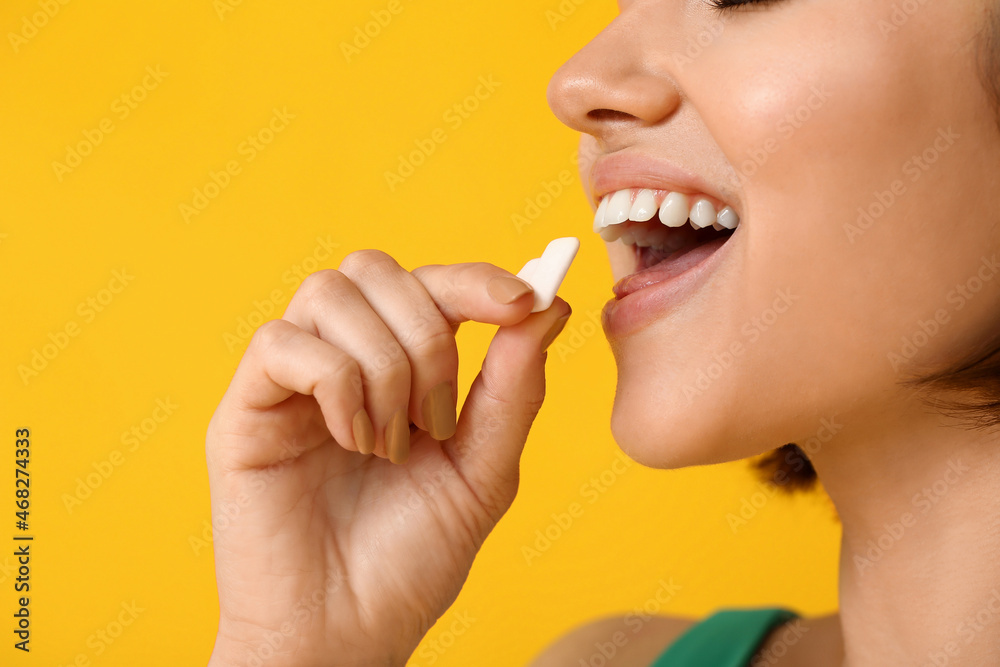 Young woman with chewing gum on color background, closeup Young woman with chewing gum on color background, closeup