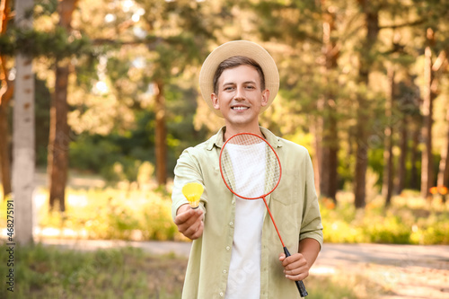 Male badminton player in park