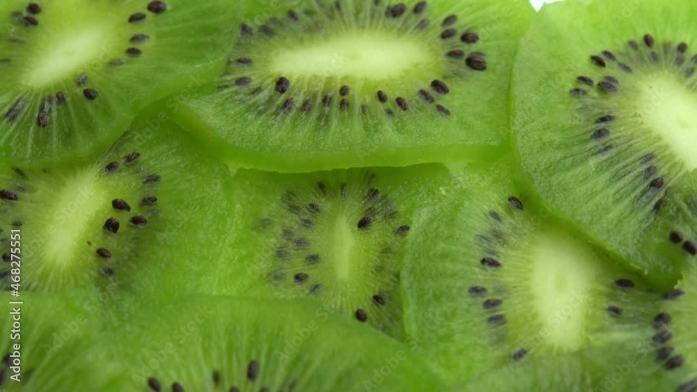 Background in the form of sliced kiwi spins, juicy green kiwi fruit or chinese gooseberry Background in the form of sliced kiwi spins, juicy green kiwi fruit or chinese gooseberry