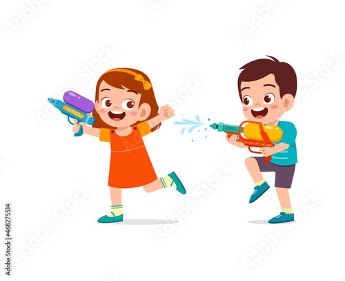 cute little kid holding water gun and play with friend
