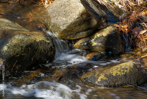 water cascading  between rocks  in a small brook in new england