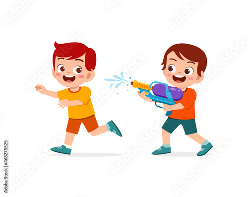 cute little kid holding water gun and play with friend