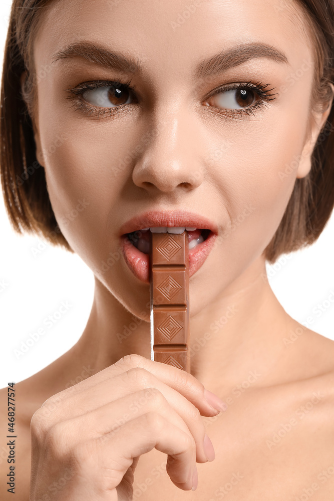 Beautiful young woman with sweet chocolate on white background Beautiful young woman with sweet chocolate on white background