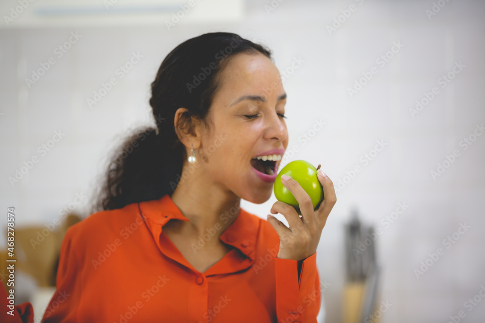 African American woman having fun and enjoy happy with a food in kitchen at home African American woman having fun and enjoy happy with a food in kitchen at home