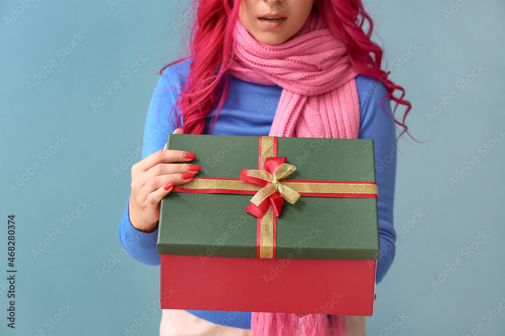 Beautiful woman opening gift box on color background Beautiful woman opening gift box on color background