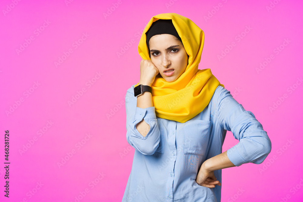 cheerful woman in yellow hijab electronic watch technology user pink background cheerful woman in yellow hijab electronic watch technology user pink background