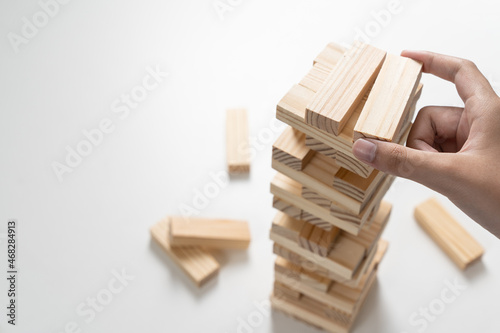 Closeup wood blocks stack game for planning, risk and strategy of project management in business concept