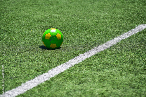 bright yellow-green soccer ball on the grass