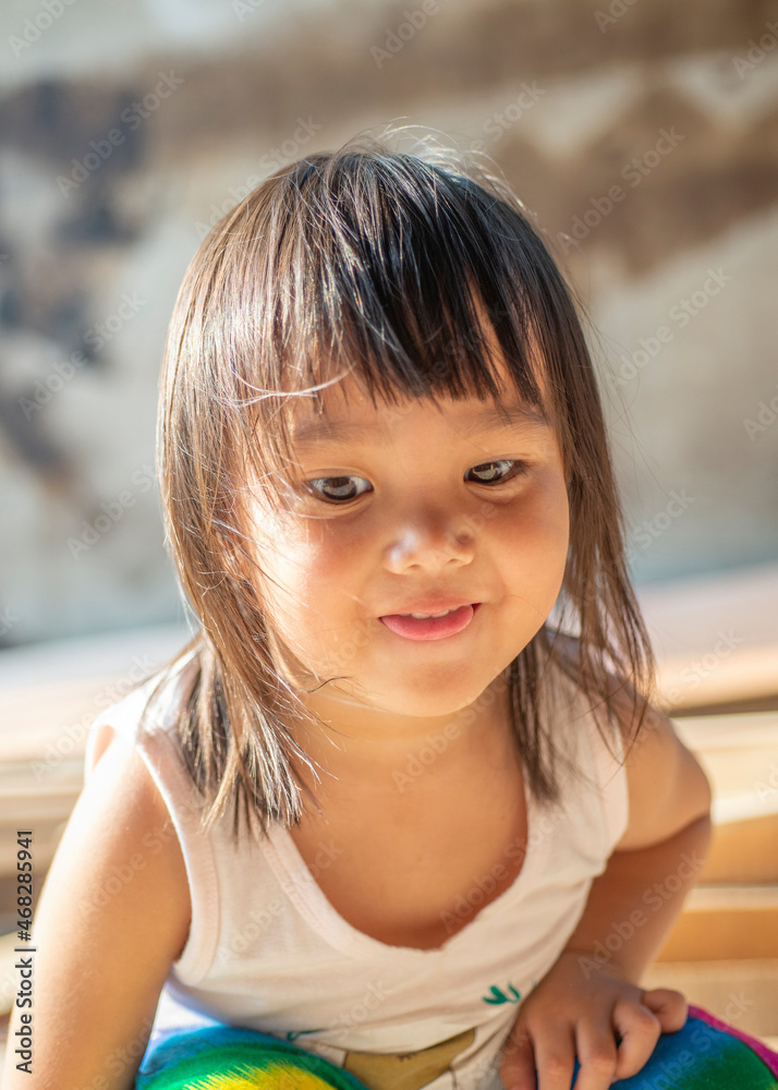 Portrait of a young child's face, an innocent Asian woman with black hair. Portrait of a young child's face, an innocent Asian woman with black hair.
