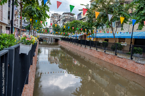 Photography Khlong Ong Ang canal with flags in downtown Bangkok Thailand