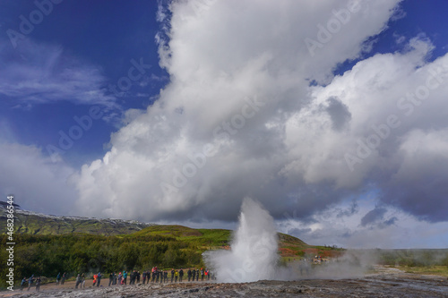 Haukadalur, Iceland: Visitors watch as the active Strokkur geyser erupts, sending jets of water and steam into the air every few minutes.