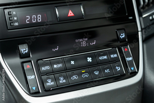 Close up Instrument automobile panel with climat control view with air conditioning buttons- details and controls of modern car.