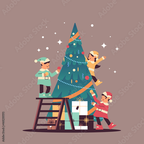 elves in uniform santa helpers team decorating fir tree happy new year merry christmas holidays celebration