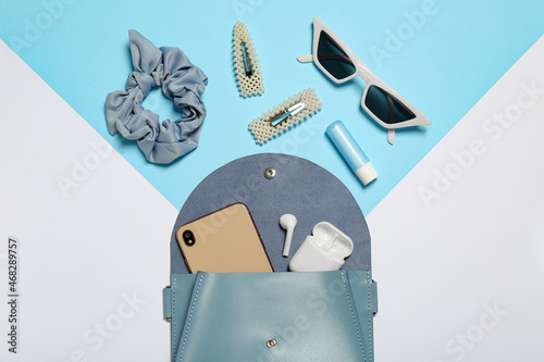 Tablou pe pânză Stylish women's bag and different stuff on color background, flat lay