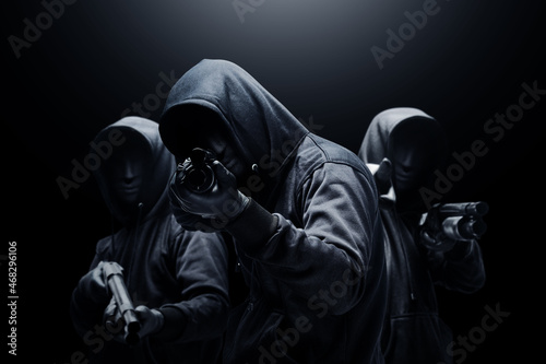 Obraz na plátně Group of criminal man in a hidden mask with a shotgun