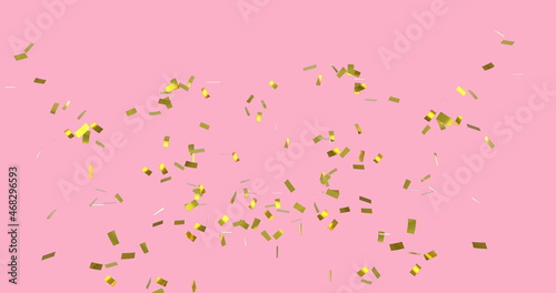 Digital image of gold confetti falling against a pink background photo
