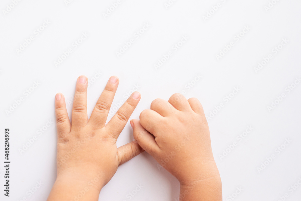 both hand and fingers of a child on a white background