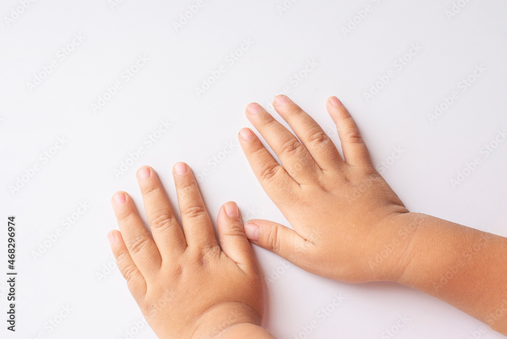 both hand and fingers of a child on a white background