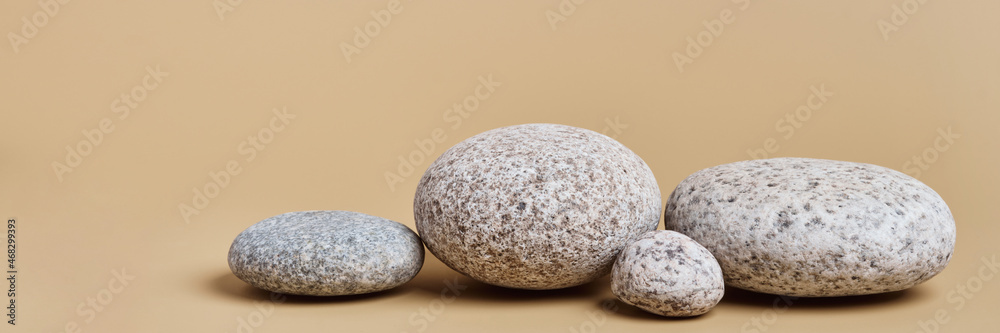 Banner with Rounded pebbles. Trending background for presentation of eco friendly and zero waste products in earth colors Banner with Rounded pebbles. Trending background for presentation of eco friendly and zero waste products in earth colors