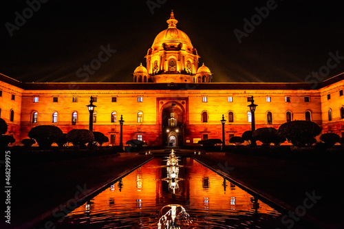 Orange light shining on the Secretariat building in New Delhi India at night time