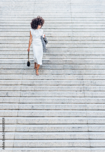 Woman alone walking down the stairs looking to the side