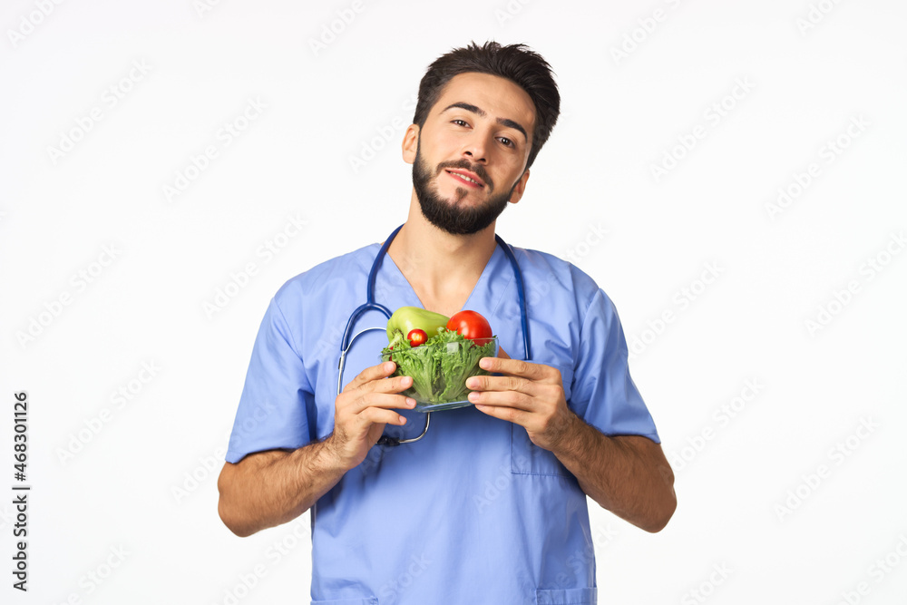Cheerful dietitian with vegetables in hands vitamins healthy food