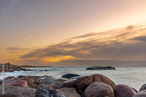 Nature background. Sunset scene at Skagen Strand Denmark. Golden sky over the sea.