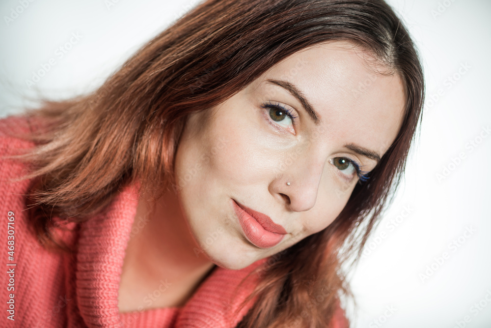 young woman portrait in pink sweater on studio background young woman portrait in pink sweater on studio background