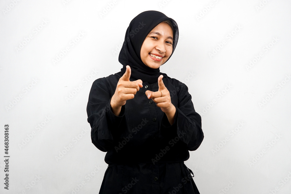 Beautiful young asian muslim woman smiling confident, enthusiastic and cheerful with hands pointing at camera, hands pointing at audience, facing camera isolated on white background Beautiful young asian muslim woman smiling confident, enthusiastic and cheerful with hands pointing at camera, hands pointing at audience, facing camera isolated on white background