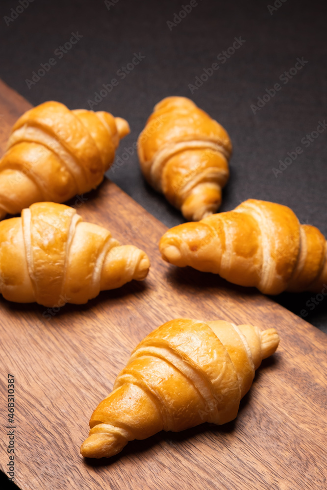 Fresh croissants on a wooden board. selective focus .bakery with copy space. Fresh croissants on a wooden board. selective focus .bakery with copy space.