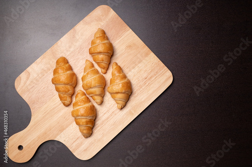Fresh croissants on a wooden board. Freshly baked with copy space.top view croissant.