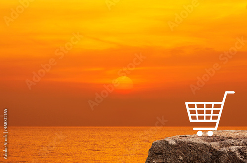 Shopping cart flat icon on rock mountain over sunset sky and sea, Business shop online concept