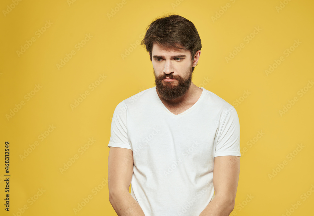 emotional man in a white t-shirt expressive look discontent Studio emotional man in a white t-shirt expressive look discontent Studio