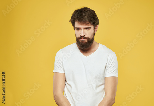 emotional man in a white t-shirt expressive look discontent Studio