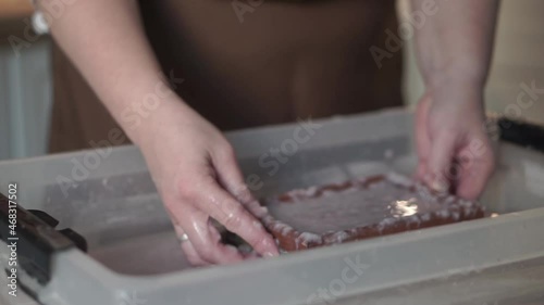 A woman holding a frame for making paper sheets from recycled paper. Selective focus. Household hobby, paper recycling. The concept of zero waste, recycling, ecology