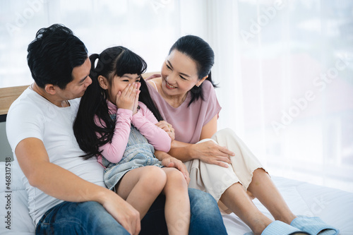 happy love family lifestyle with Asian father and mother and child daughter at home together
