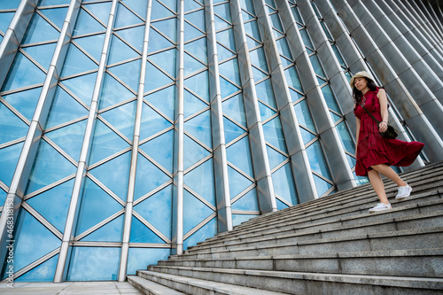 Asian woman in red dress at...