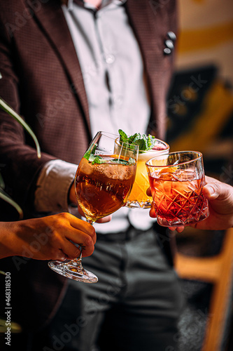 Photography Three humans cling with different cocktail glasses