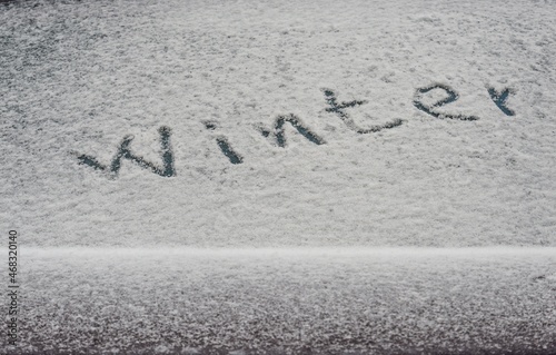 The inscription on the snow on the rear window of the car.