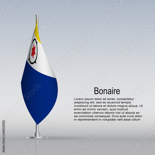 Flag of Bonaire hanging on a flagpole stands on the table